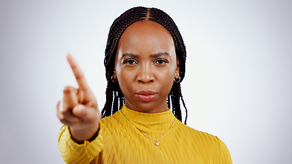 Image showing No finger, black woman and angry portrait with protest, caution and wrong hand sign in a studio. Stop, white background and serious African female person with refuse, rejection and forbidden gesture