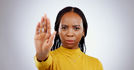 Image showing Stop hand, black woman and angry portrait with protest, caution and palm sign in a studio. Warning, white background and serious African female person with refuse, rejection and forbidden gesture