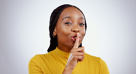 Image showing Secret, woman and portrait with finger on lips in studio for sign of privacy, confidential deal and surprise on white background. Face of african model show quiet emoji for gossip, news and whisper