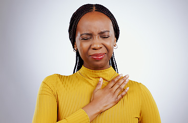 Image showing Heart pain, black woman and ache with stress, anxiety and problem from cardiology crisis in studio. White background, African female person and heartburn with cardiac arrest and sick from grief