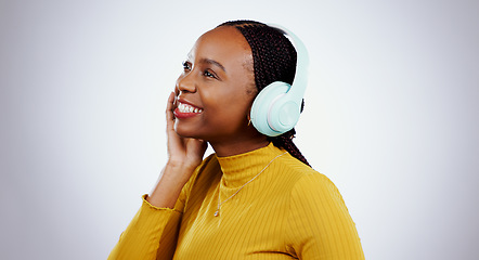 Image showing Woman, headphones and listening to music or smile, audio and song in studio by gray background. Black female model, hearing and streaming radio, sound and playlist for peace, chilling and mockup