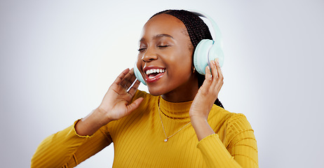 Image showing Woman, headphones and listening to music or dance, audio and song in studio by gray background. Black female model, hearing and streaming radio, sound and playlist for peace, chilling and mockup