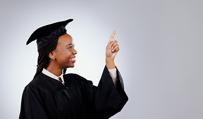 Image showing Graduate, woman pointing up and space for education, learning or college presentation and study opportunity in studio. African student information, registration steps or offer on a white background