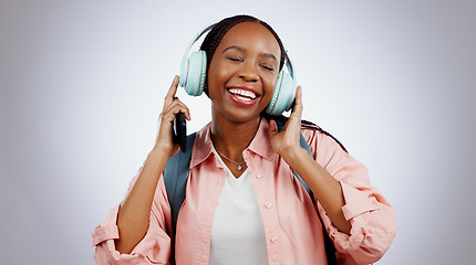 Image showing Music, student or happy black woman in studio listening to radio playlist to relax on grey background. Face, headphones or African person with smile singing or streaming a song audio or sound track