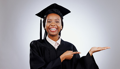 Image showing Graduate, black woman and portrait with pointing to college deal and academy promotion in studio. Happy, university student and school marketing with white background and African person with study