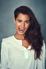 Image showing Funny face, tongue and portrait of woman, silly and confident by backdrop, hair and casual fashion. Happy female person, beauty and cosmetics or goofy, care and joke or posing, comedy and crazy