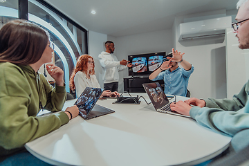 Image showing A diverse group of businessmen collaborates and tests a new virtual reality technology, wearing virtual glasses, showcasing innovation and creativity in their futuristic workspace