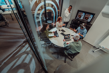 Image showing A diverse group of businessmen collaborates and tests a new virtual reality technology, wearing virtual glasses, showcasing innovation and creativity in their futuristic workspace