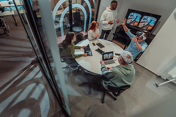 Image showing A diverse group of businessmen collaborates and tests a new virtual reality technology, wearing virtual glasses, showcasing innovation and creativity in their futuristic workspace