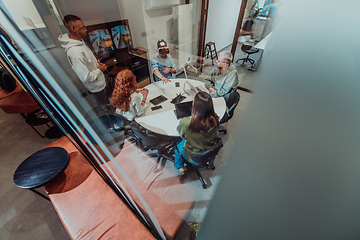 Image showing A diverse group of businessmen collaborates and tests a new virtual reality technology, wearing virtual glasses, showcasing innovation and creativity in their futuristic workspace