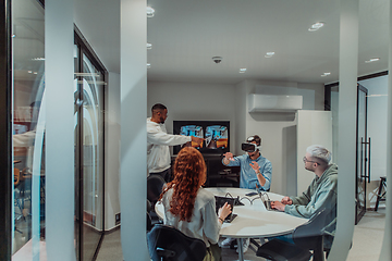 Image showing A diverse group of businessmen collaborates and tests a new virtual reality technology, wearing virtual glasses, showcasing innovation and creativity in their futuristic workspace