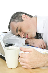 Image showing Businessman asleep at his desk on white background