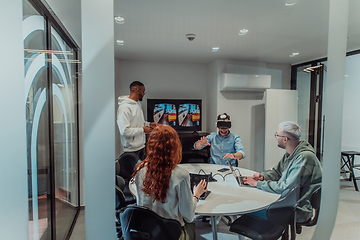 Image showing A diverse group of businessmen collaborates and tests a new virtual reality technology, wearing virtual glasses, showcasing innovation and creativity in their futuristic workspace