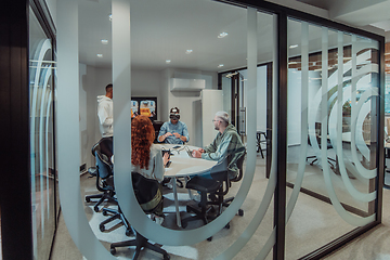 Image showing A diverse group of businessmen collaborates and tests a new virtual reality technology, wearing virtual glasses, showcasing innovation and creativity in their futuristic workspace