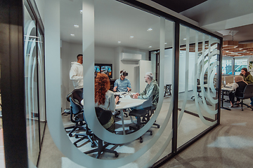 Image showing A diverse group of businessmen collaborates and tests a new virtual reality technology, wearing virtual glasses, showcasing innovation and creativity in their futuristic workspace