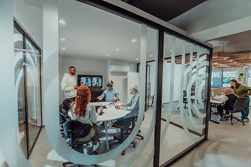 Image showing A diverse group of businessmen collaborates and tests a new virtual reality technology, wearing virtual glasses, showcasing innovation and creativity in their futuristic workspace