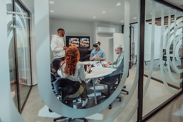 Image showing A diverse group of businessmen collaborates and tests a new virtual reality technology, wearing virtual glasses, showcasing innovation and creativity in their futuristic workspace