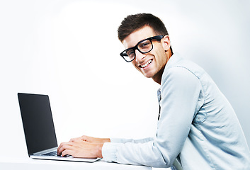Image showing Portrait, business man typing on laptop at table and isolated on white background. Face, smile and geek at desk on computer, technology and IT programmer in glasses, coding and mockup space in Canada