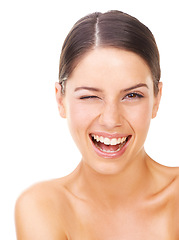 Image showing Happy woman, portrait and face with wink for skincare, makeup or beauty against a white studio background. Young female person or model smile in satisfaction for facial treatment, health and wellness