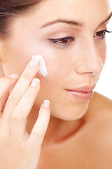 Image showing Face cream, application and woman in studio for skincare, wellness or cosmetics closeup. Facial, sunscreen and female model with luxury skin product, lotion or spf, anti aging and collagen treatment