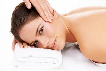 Image showing Portrait, massage and beauty with a woman at the spa in studio isolated on a white background to relax. Hands, face and head with a happy young salon customer on a table for luxury wellness treatment