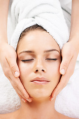 Image showing Spa massage, peace and hands on face of woman from above at resort for stress relief or wellness. Top view, facial and female client with masseuse at beauty salon for luxury, skincare or dermatology