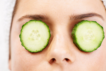 Image showing Woman, face and cucumber on eyes for wellness, cosmetic or spa therapy with closeup, relax and peace. Person, skincare or detox treatment for beauty, skin or stress relief and relaxation or wellbeing