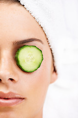 Image showing Woman, face and cucumber on eye for wellness, cosmetic or spa therapy with closeup, relax and peace. Person, skincare or detox treatment for beauty, skin or stress relief and relaxation or wellbeing