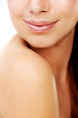 Image showing Body, skincare and woman closeup in shower with shoulder, hygiene and white background for dermatology in studio. Girl, water and cosmetics treatment for health, wellness or wet glow on clean skin