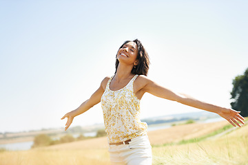 Image showing Happy, freedom and woman with arms raised at field outdoor in the countryside in spring. Person in nature, eyes closed and relax at farm, breathe fresh air or enjoy vacation, travel and peace or calm