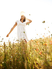 Image showing Springtime, field and freedom with woman, countryside and happiness with weekend break, carefree and flowers. Person, outdoor or girl in a dress, summer and holiday with environment, grass or nature