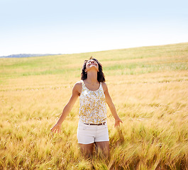 Image showing Breathing, freedom or happy woman in a field in the countryside in spring to relax on break. Smile, wellness or female person in farm for fresh air on holiday vacation, gratitude or travel in nature