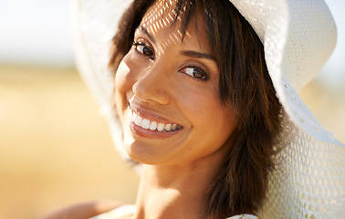 Image showing Portrait, happy woman in hat at field or countryside in summer outdoor, beauty or health. Face, smile and young person at farm, nature and garden to travel on holiday, vacation or tourism in Brazil