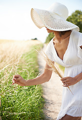 Image showing Sunshine, wheat field and woman with nature, countryside and environment with break, weekend and landscape. Person, girl or traveller with freedom, exploring and plants with ecology, spring or summer