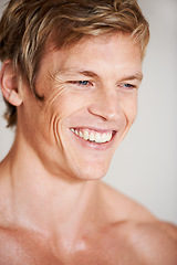 Image showing Man, topless and smile in studio or white background for positive energy, healthy or confidence. Male person, model or shirtless relax masculine for strong shoulders or attractive, calm or muscle