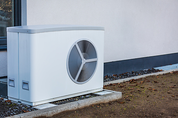 Image showing Air source heat pump installed outside a house