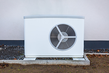 Image showing Air source heat pump installed outside a house