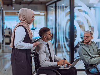 Image showing Young group of business people brainstorming together in a startup space, discussing business projects, investments, and solving challenges.