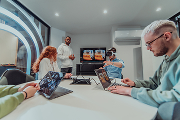 Image showing A diverse group of businessmen collaborates and tests a new virtual reality technology, wearing virtual glasses, showcasing innovation and creativity in their futuristic workspace