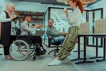 Image showing Young group of business people brainstorming together in a startup space, discussing business projects, investments, and solving challenges.