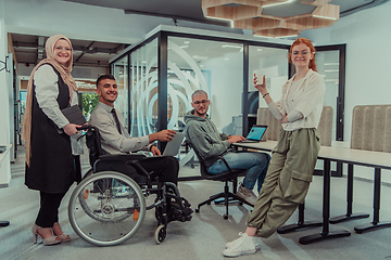 Image showing Young group of business people brainstorming together in a startup space, discussing business projects, investments, and solving challenges.