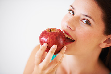 Image showing Health, fruit and portrait of woman with apple eating for nutrition, wellness and snack in studio. Food, balance diet and face of happy person for vitamins, detox and lose weight on white background
