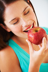 Image showing Health, diet and face of woman with apple eating for nutrition, wellness and snack in studio. Food, happy and person with fruit for vitamins, detox benefits and lose weight on white background