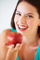 Image showing Health, happy and portrait of woman with apple for nutrition, wellness and snack in studio. Food, balance diet and face of person with fruit for vitamins, detox and lose weight on white background