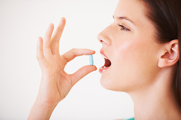 Image showing Healthy, woman and pill or tablet in hand for nutrition, diet and vitamin c supplement for benefits. Girl, eating and pharmaceutical capsule with omega 3, iron and healthcare medicine with magnesium