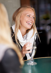 Image showing Friends, woman and drink in a cafe, relax and happiness with conversation, weekend break and laughing. People, girl and restaurant with a glass, speaking and funny with humor, talking and discussion