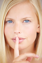 Image showing Woman, quiet and finger on lips in portrait with sign, secret deal or story for promotion by background. Girl, hand and mouth for silence icon, whisper or gossip for voice, news or privacy in closeup