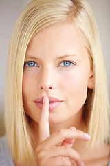 Image showing Woman, silence and finger on lips in portrait with sign, secret deal or story for promotion by background. Girl, hand and mouth for icon, whisper or gossip for quiet voice, news or privacy in closeup