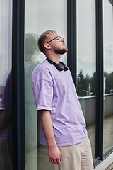 Image showing In front of a modern glass building, a young, blond influencer strikes a confident pose, epitomizing urban glamour and style in the heart of the city