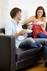 Image showing Couple, dinner and living room couch with conversation an discussion with food and chopsticks. Lounge, happy and marriage with lunch and eating with a smile and communication on a sofa with love